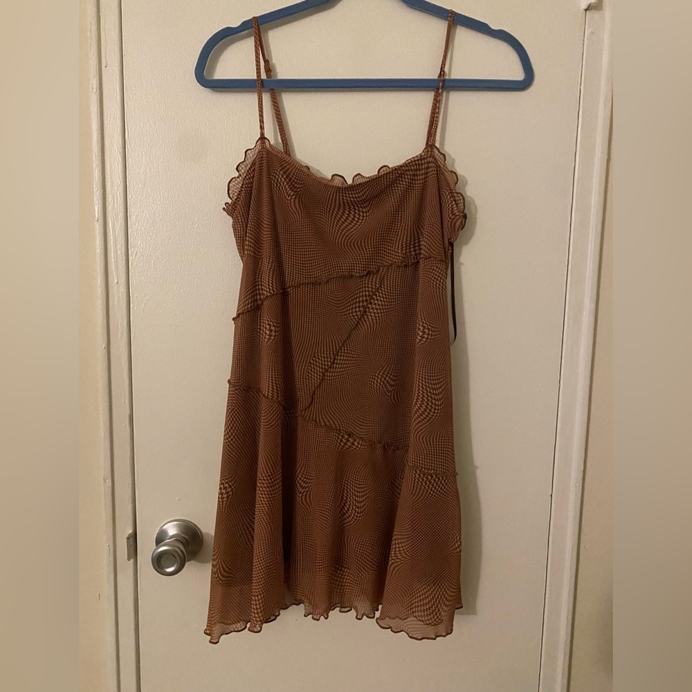 Brown patterned dress that’s a flowy fit, it is from Urban Outfitters and is a M